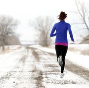 an athletic woman jogging in the winter fasted cardio